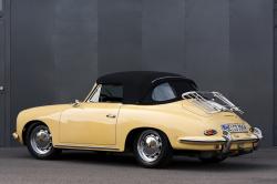 Dusseldorf, Germany - June 17, 2009: A perfectly restored light yellow Porsche 356 C convertible in front of a grey steel wall. by foodbytes